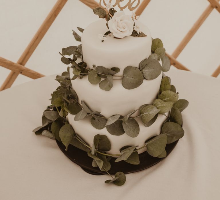 Homemade Three-Tier Iced Fruit Cake Wrapped with Eucalyptus | Laser Cut Cake Topper | Yurt Wedding with Outdoor Naked Tipi Ceremony, Glitter Station &amp; Peach Rewritten Bridesmaid Dresses | Nesta Lloyd Photography