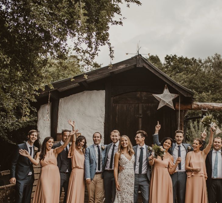 Bride in Sasha Dress by Made With Love with Crochet Finish, Fishtail Train, V-Neck and Plunging Back | Groom in Light Blue Two-Piece Suit by Hugo Boss | Bridesmaids in Mismatched Peach Rewritten Dresses, Tops and Skirts | Groomsmen in Mismatched Blue Hugo Boss Suits | Yurt Wedding with Outdoor Naked Tipi Ceremony, Glitter Station &amp; Peach Rewritten Bridesmaid Dresses | Nesta Lloyd Photography