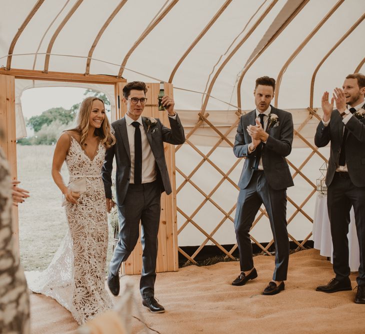 Bride in Sasha Dress by Made With Love with Crochet Finish, Fishtail Train, V-Neck and Plunging Back | Groom in Light Blue Two-Piece Suit by Hugo Boss | Blush Buttonhole | Yurt Wedding with Outdoor Naked Tipi Ceremony, Glitter Station &amp; Peach Rewritten Bridesmaid Dresses | Nesta Lloyd Photography