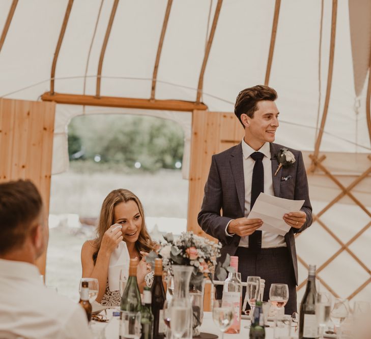 Bride in Sasha Dress by Made With Love with Crochet Finish, Fishtail Train, V-Neck and Plunging Back | Groom in Light Blue Two-Piece Suit by Hugo Boss | Blush Buttonhole | Yurt Wedding with Outdoor Naked Tipi Ceremony, Glitter Station &amp; Peach Rewritten Bridesmaid Dresses | Nesta Lloyd Photography