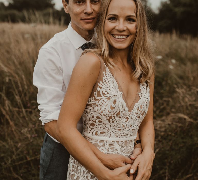 Bride in Sasha Dress by Made With Love with Crochet Finish, Fishtail Train, V-Neck and Plunging Back | Groom in Light Blue Two-Piece Suit by Hugo Boss | Yurt Wedding with Outdoor Naked Tipi Ceremony, Glitter Station &amp; Peach Rewritten Bridesmaid Dresses | Nesta Lloyd Photography