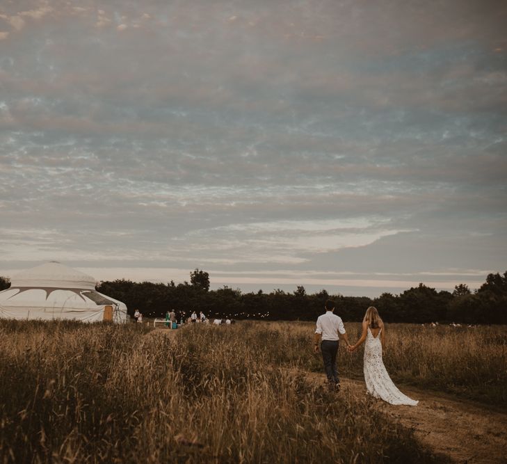 Bride in Sasha Dress by Made With Love with Crochet Finish, Fishtail Train, V-Neck and Plunging Back | Groom in Light Blue Two-Piece Suit by Hugo Boss | Wedding Reception at Sychpwll Centre in Wales | Yurt Wedding with Outdoor Naked Tipi Ceremony, Glitter Station &amp; Peach Rewritten Bridesmaid Dresses | Nesta Lloyd Photography