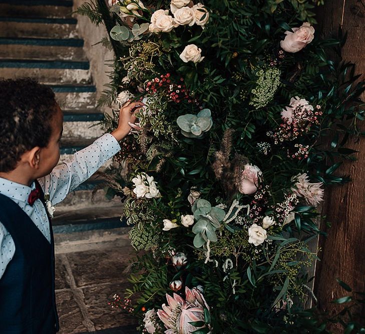 Little wedding guest admiring the wedding flowers by Leafy Couture