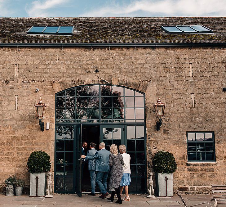 Groom welcoming wedding guests to Wharfedale Grange wedding ceremony