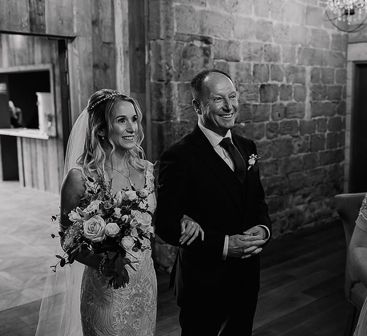 Father of the bride escorting his daughter down the aisle