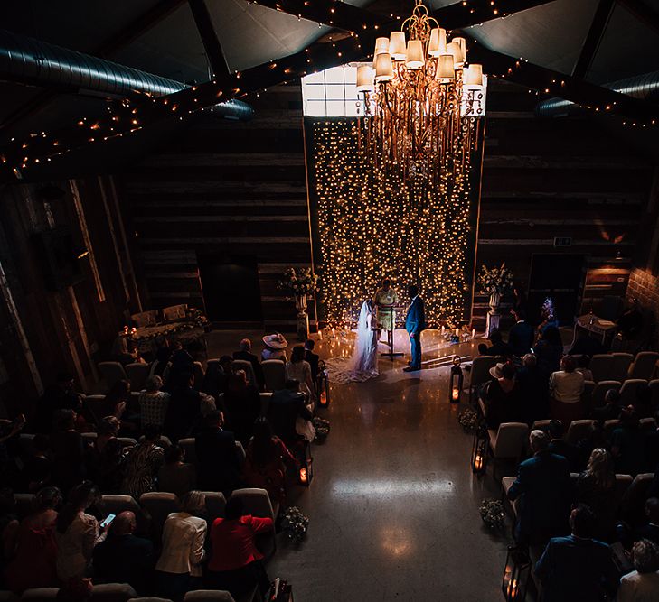 Wedding ceremony at Wharfedale Grange with fairy light backdrop