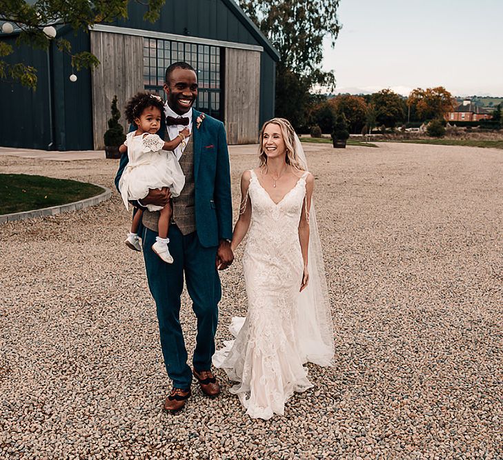 Family portrait of bride, groom and daughter by Abbie Sizer Photography