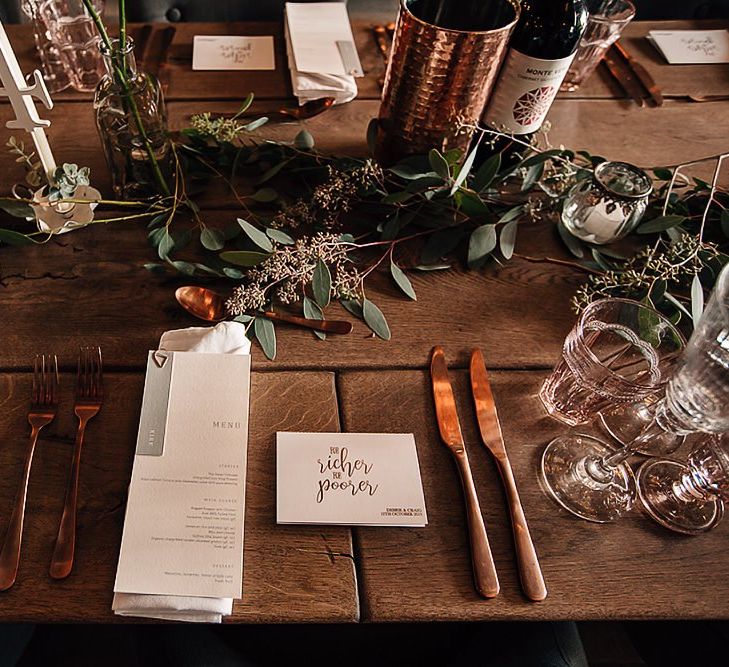 Place setting with copper cutlery and menu card