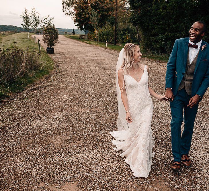 Bride and groom portrait at Wharfedale Grange with bride in lace dress and groom in checked waistcoat and bow tie