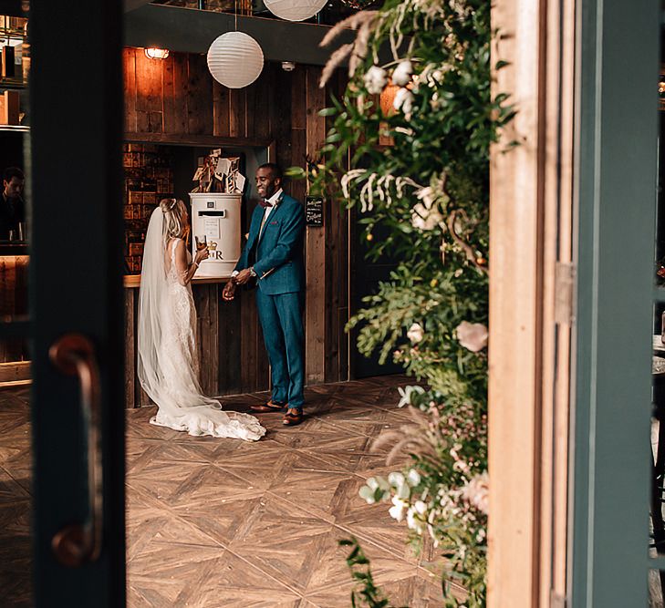 Bride and groom enjoying a drink at the bar