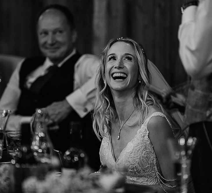 Beautiful bride smiling during grooms speech