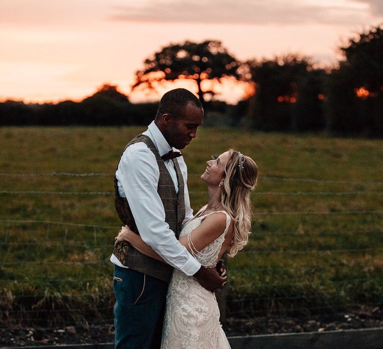 Golden hour portrait with bride in Madison James wedding Dress and groom in Marc Darcy suit