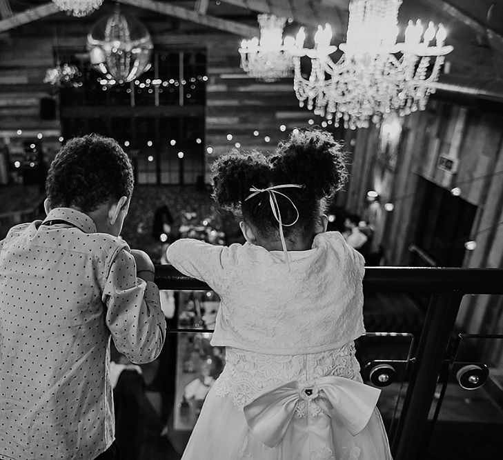 Flower girl and page boy looking over the mezzanine at Wharfedale Grange wedding venue