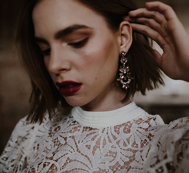 Bridal Accessories | Earrings | Bride in Cap Sleeve &amp; High Neck Lace Bridal Gown | Deep Florals Wedding Inspiration at The Grange at Northington Planned &amp; Styled by Wed &amp; Bash | Sara Lincoln Photography