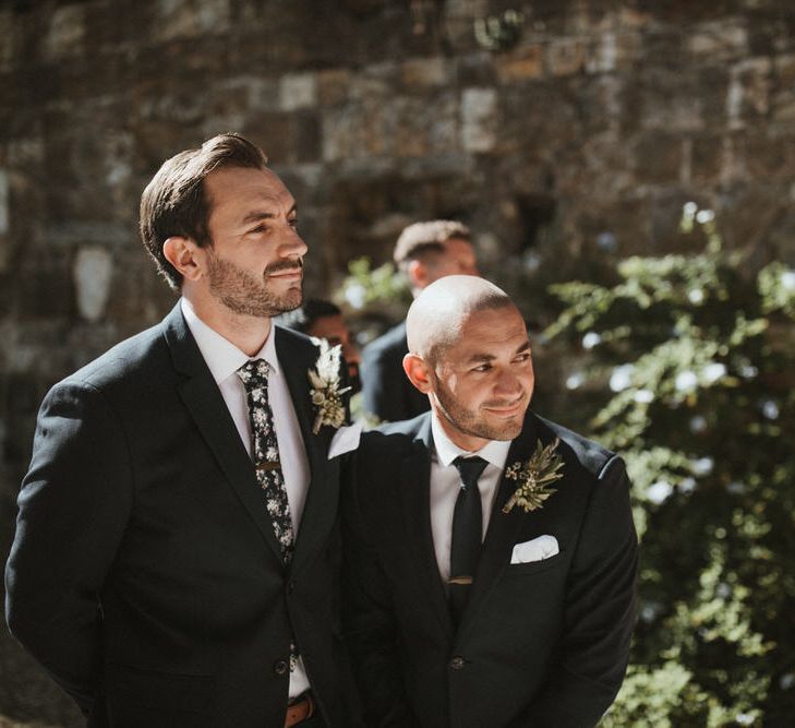 Groom In Navy Suit With Dark Floral Tie // Image By James Frost Photography