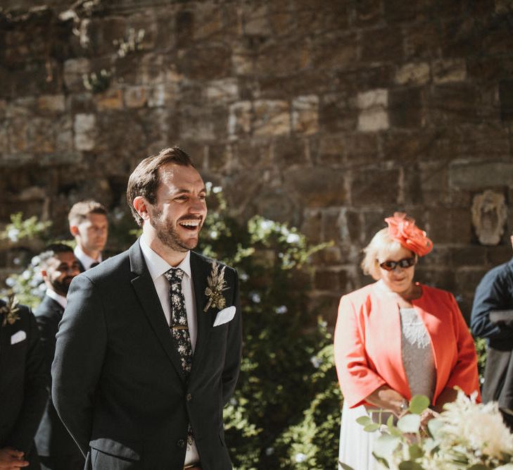 Groom In Navy Suit With Dark Floral Tie // Image By James Frost Photography