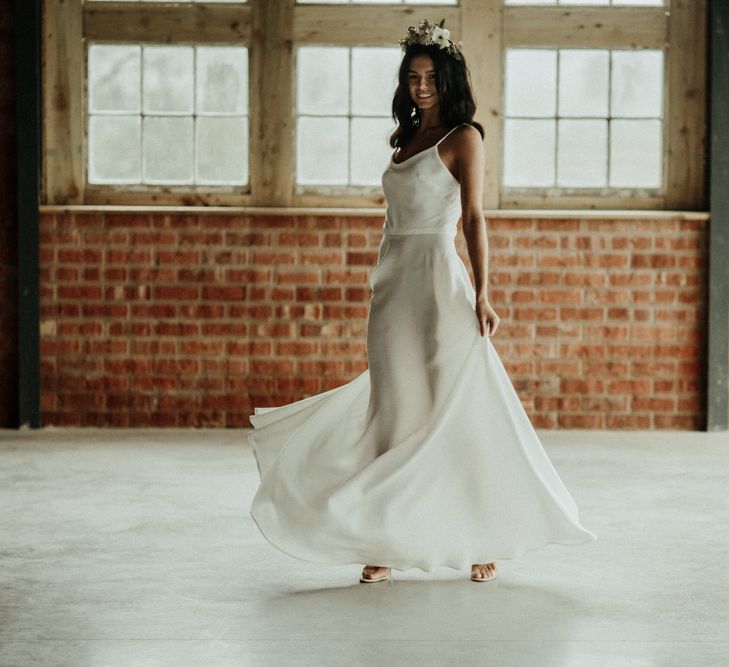 Bride in slinky wedding dress with spaghetti straps