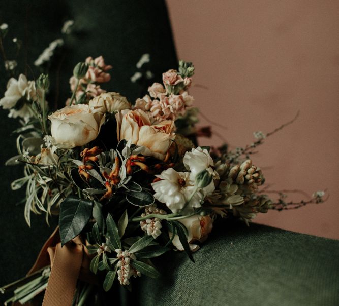 Muted flower wedding bouquet tied with ribbon.