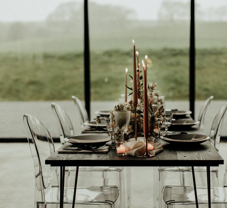 Elegant tablescape with coloured taper candles and ghost chairs