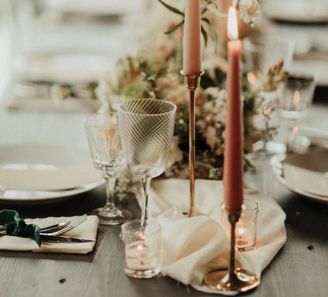 Pink taper candles in gold candlesticks