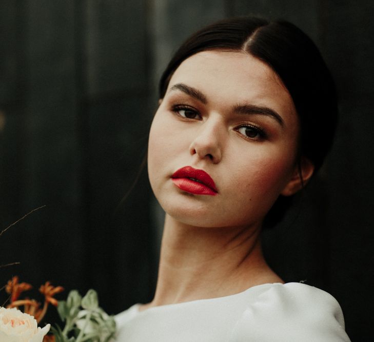 Bride in sleek bun with red lipstick