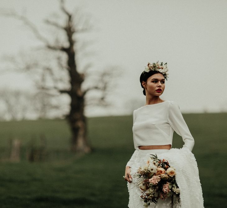 Boho bride in flower crown and bridal crop top with long sleeves