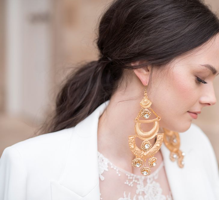 Bride with Gold Statement Earrings and Sleek Ponytail Hairstyle