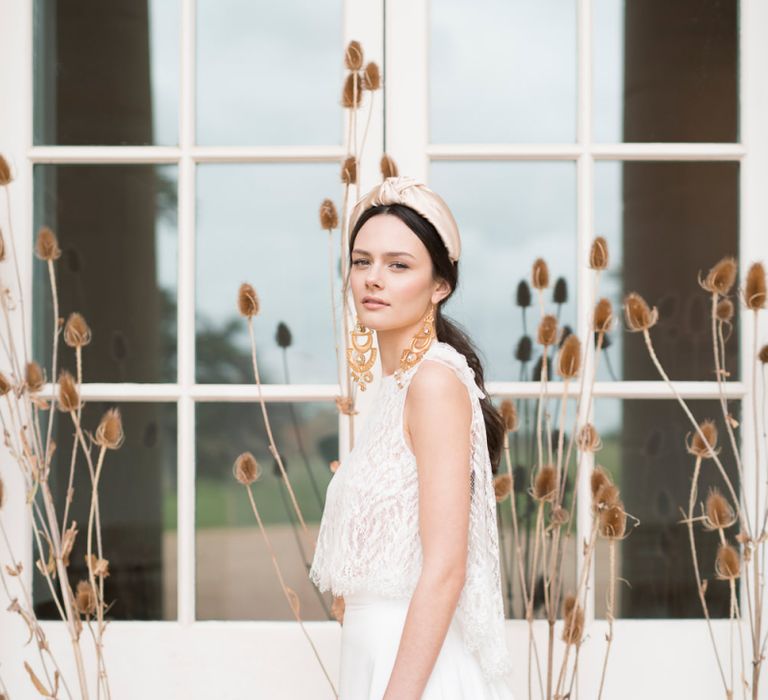 Bride in Jesus Peiro Wedding Dress with Turband Headband and Statement Gold Earrings