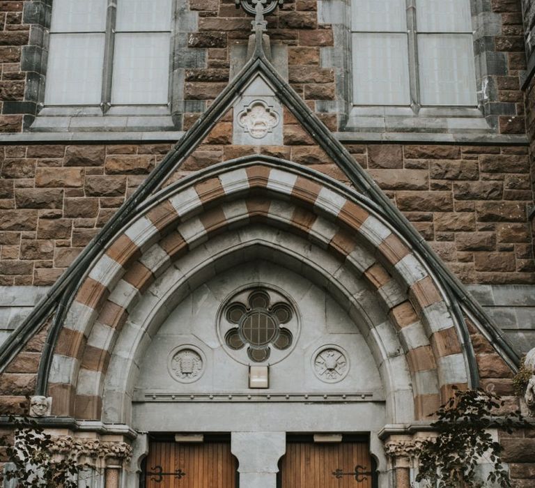 Bride and Groom Standing Outside the Church