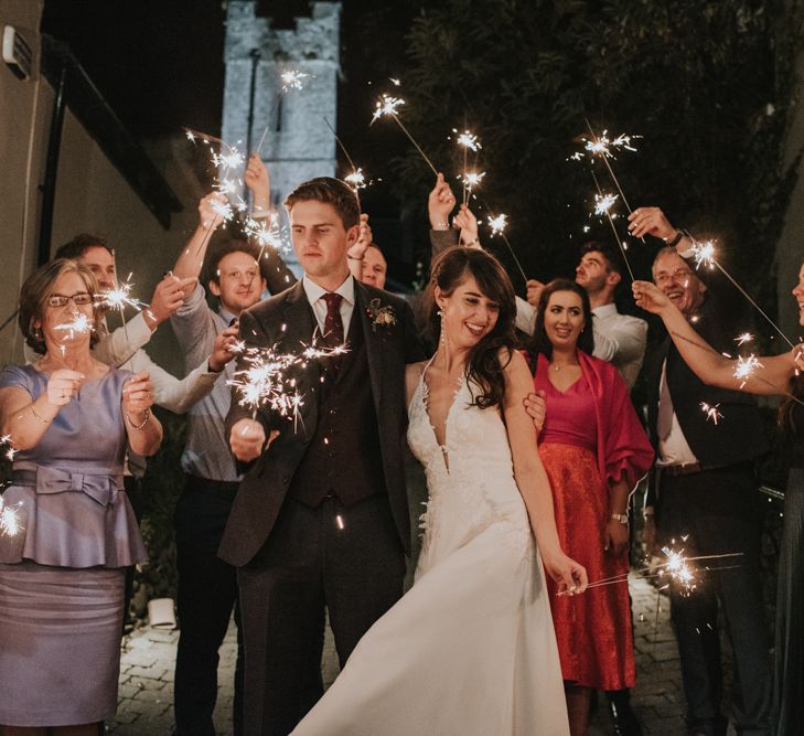 Sparkler Moment with Bride in Elbeth Gillis Wedding Dress and Groom in  Tweed Suit