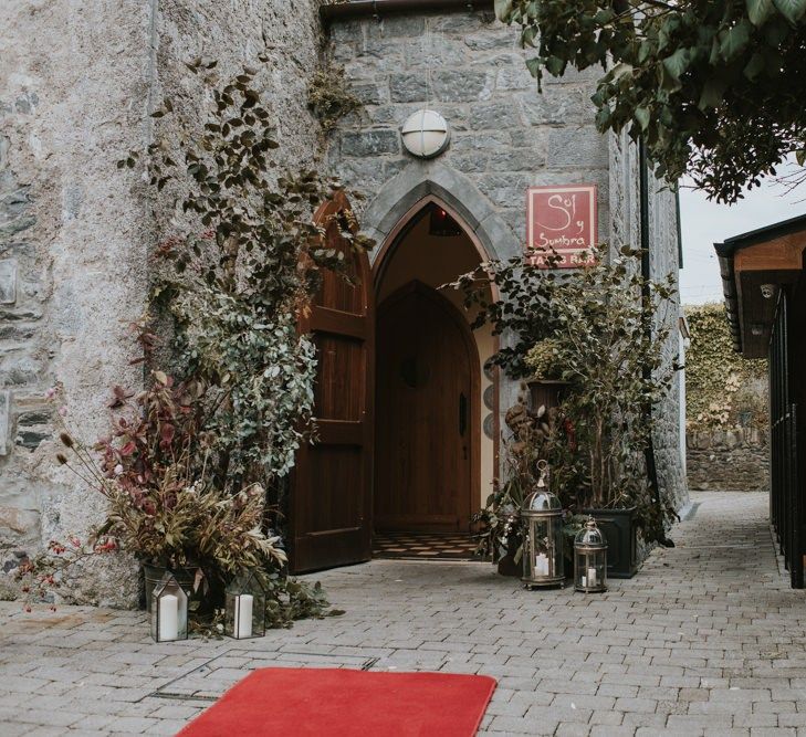 Deep Red and Green Doorway Wedding Flower Arrangements