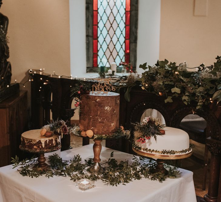 Cake Table with Homemade Wedding Cakes Decorated with Foliage