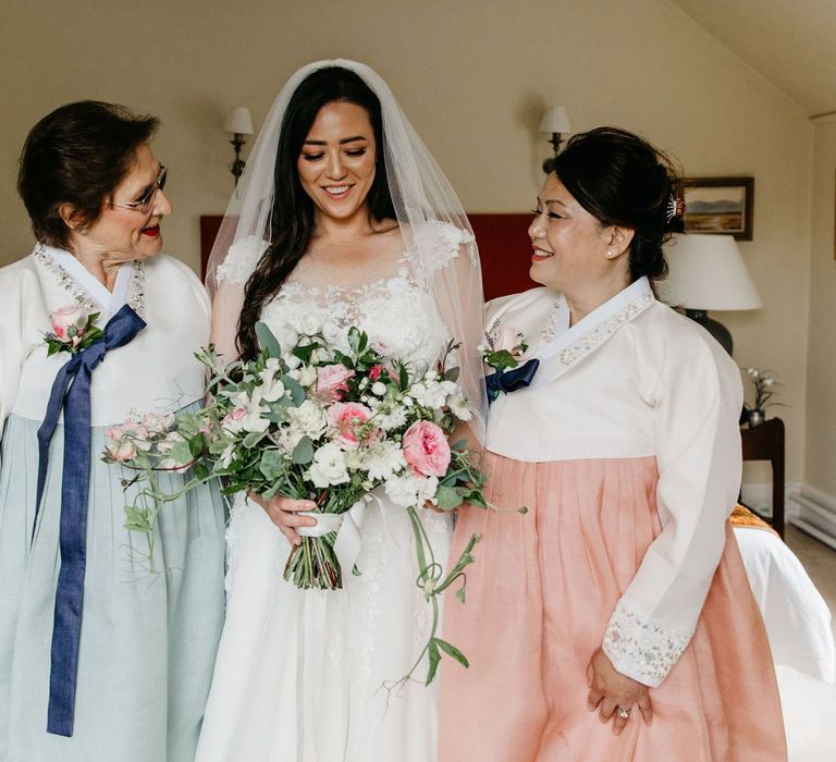 Wedding morning bridal preparations with mother of the bride and groom in Hanboks - Korean wedding dress