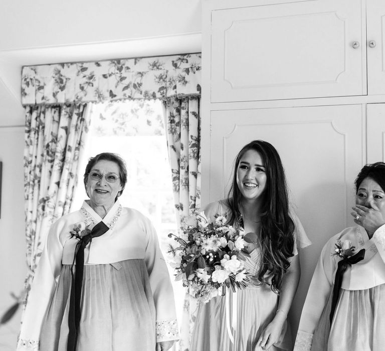 Emotional bridal party first look with mother of the bride in Korean wedding dress