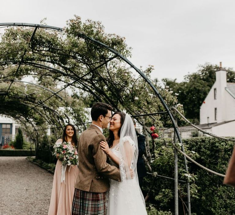 Bride and groom kissing at socially distanced wedding