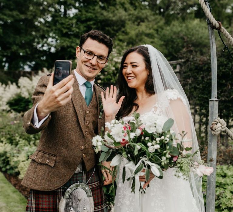 Bride and groom face timing guests after their socially distanced wedding ceremony