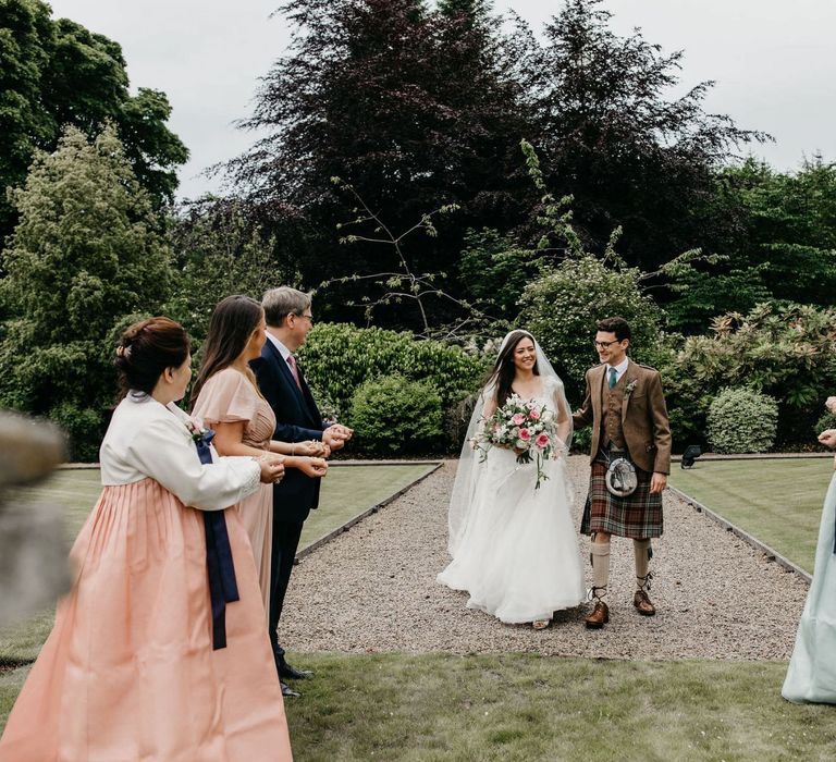 Socially distanced confetti moment with Mothers in Korean wedding dress