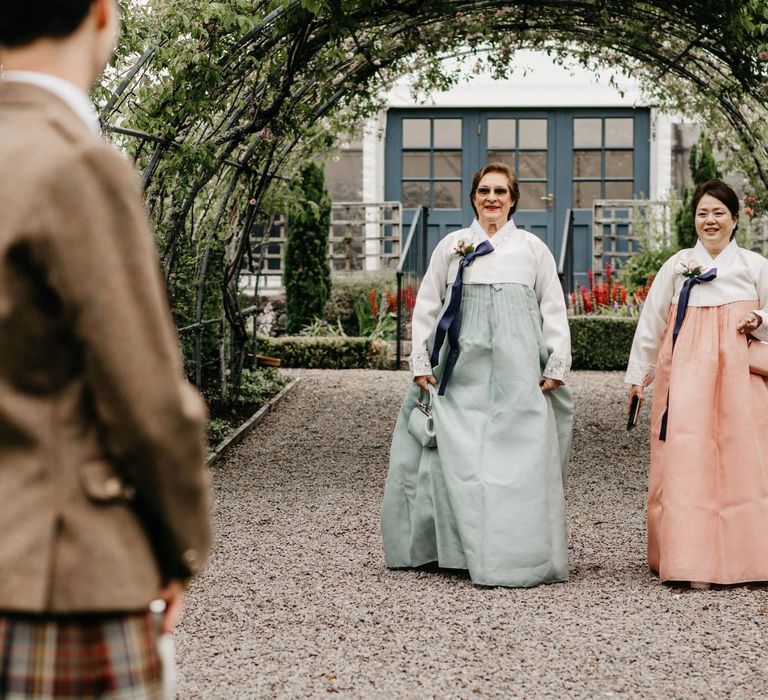 Mother of the bride and groom in complementing Hanboks - Korean wedding dress