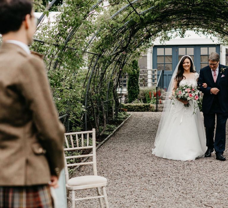 Wedding ceremony bridal entrance in lace and tulle wedding dress