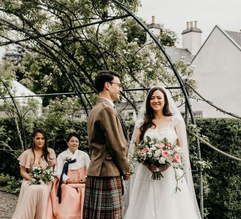 Bride and groom exchanging vows at socially distanced wedding ceremony