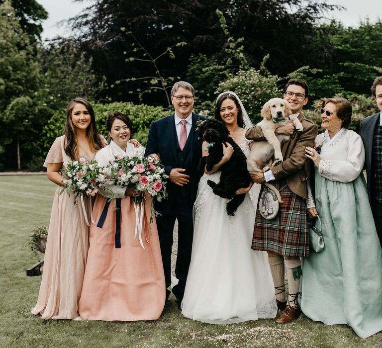 Intimate wedding party portrait with pet dogs