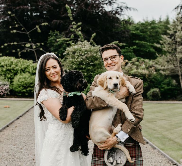 Bride and groom with their pet dogs