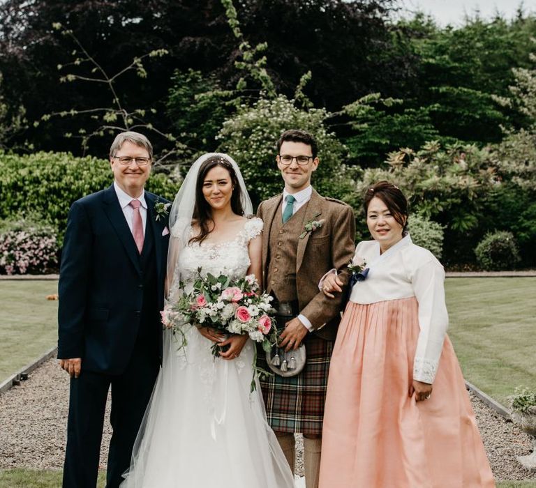 Bride and groom with the brides parents in Korean wedding dress