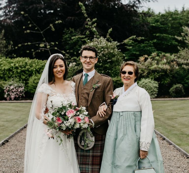 Mother of the groom in a Koren Hanbok with the happy couple