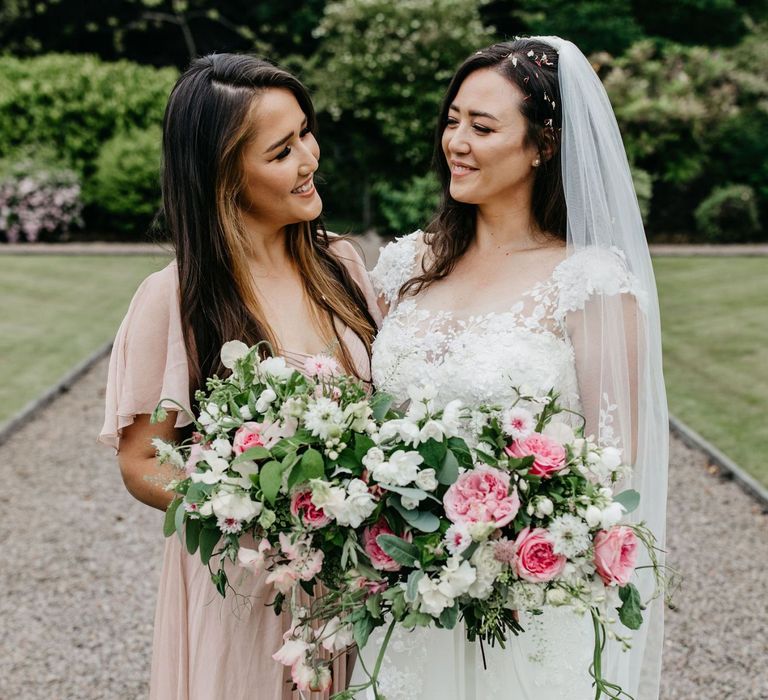 Bride with her bridesmaid in a dusky pink dress