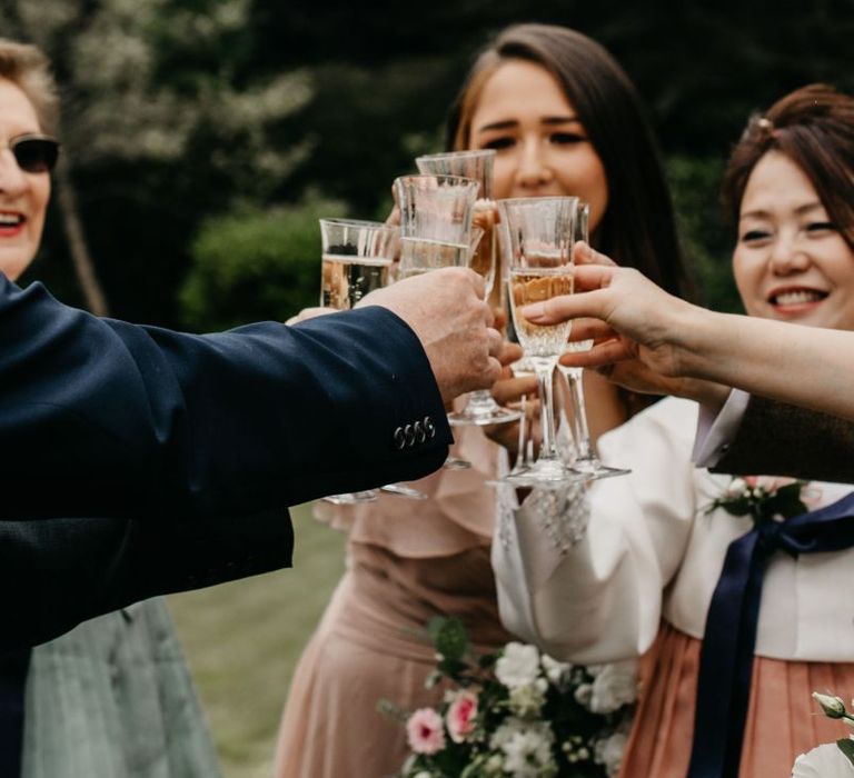 Clinking Champagne Glasses at intimate wedding