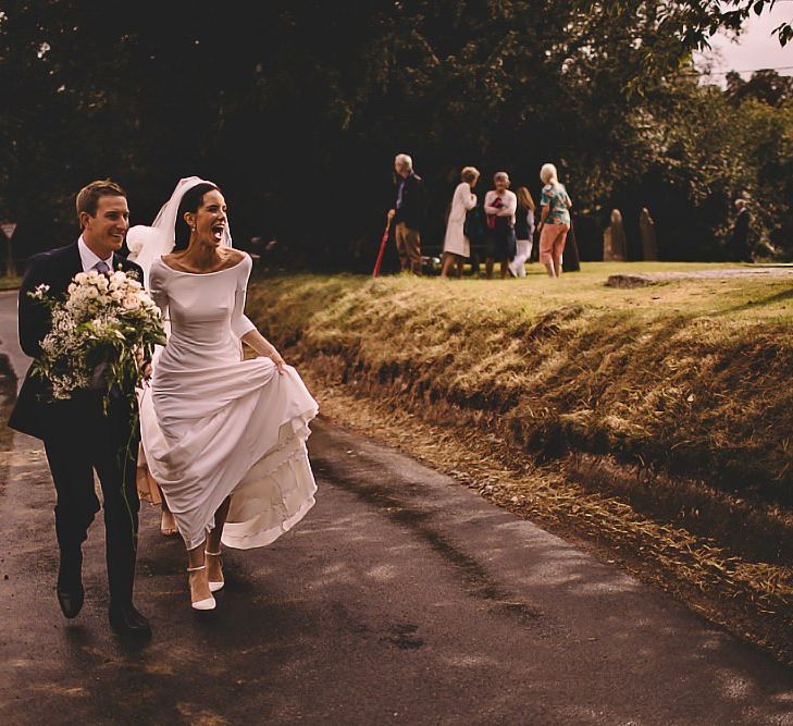 Bride and groom with beautiful white rose bouquet