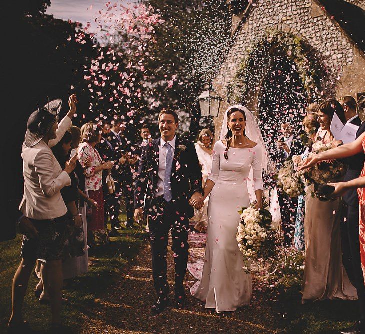 Church wedding confetti shot with white rose bouquet