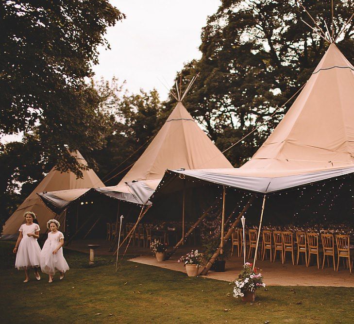 Garden party tipi reception in August with home-grown flower decor and rustic styling