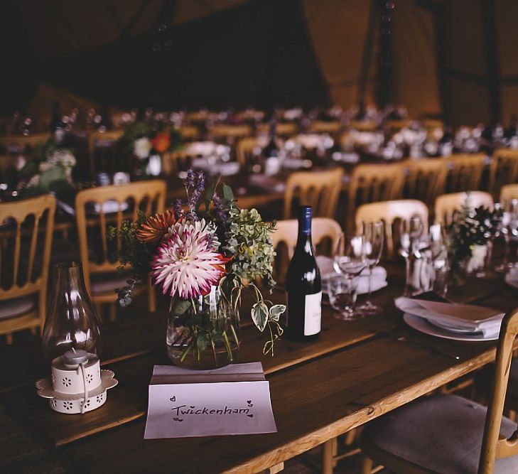 Garden party tipi reception in August with home-grown floral table arrangements